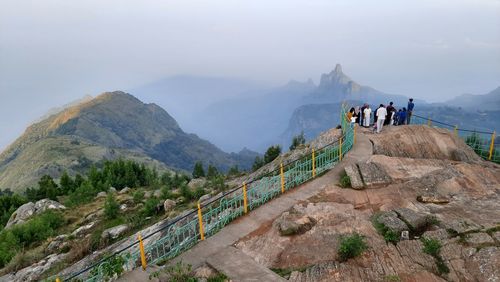 People on mountain against sky