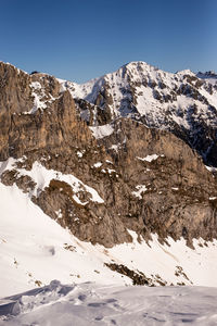 Scenic view of snowcapped mountains against clear sky