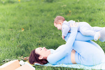 Women lying on field