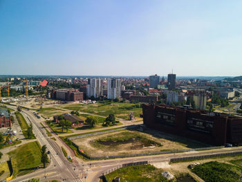 High angle view of city buildings against clear sky
