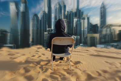 Rear view of man sitting on chair