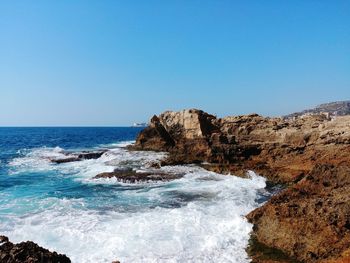 Scenic view of sea against clear blue sky