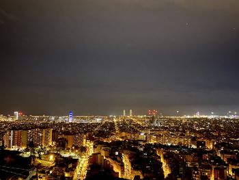 High angle view of city lit up at night