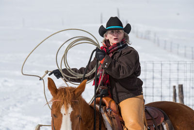 Woman riding horse during winter