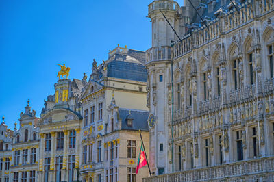 Low angle view of buildings against blue sky