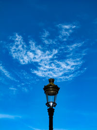 Low angle view of street light against blue sky