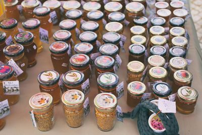 High angle view of honey jars for sale at street market stall