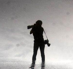 Full length of woman standing in the dark