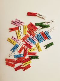 Close-up of colorful flags hanging over white background