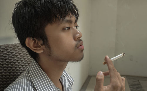 Portrait of man smoking cigarette