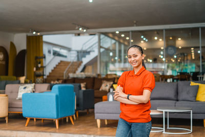 Portrait of young woman standing in cafe