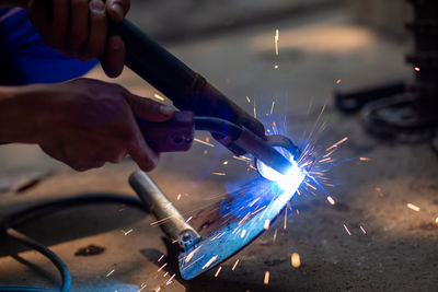 Welding spark iron, not wearing safety gloves.