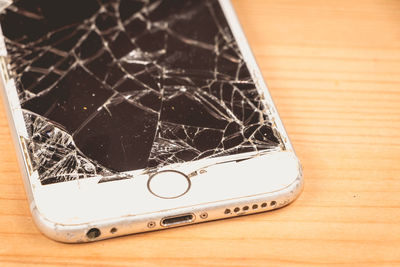 Close-up of broken smart phone on table