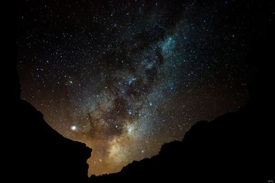 Low angle view of silhouette stars against sky at night