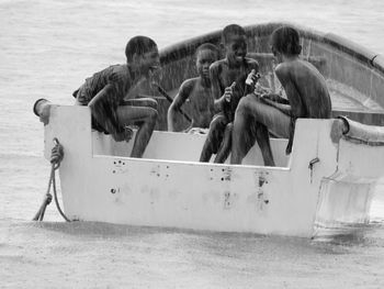 People sitting on boat at beach