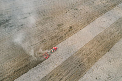 Aerial view of tractor , combine cultivating field. drone shot. picture with space for text. 