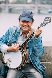 Portrait of man playing guitar