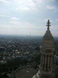 Aerial view of city against cloudy sky