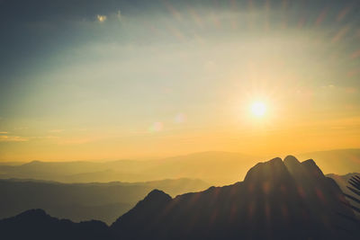 Scenic view of silhouette mountains against sky during sunset