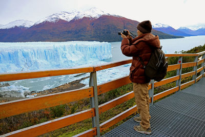Full length of man photographing glaciers