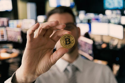 Businessman holding bitcoin in office