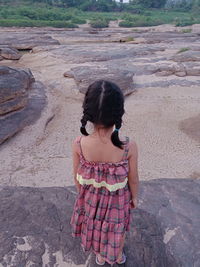 Rear view of girl standing outdoors