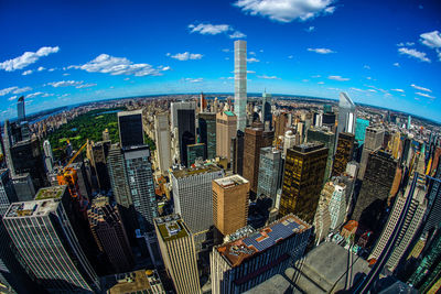 High angle view of modern buildings against blue sky