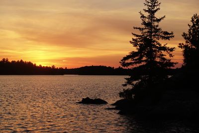 Scenic view of river at sunset