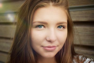 Close-up portrait of smiling young woman