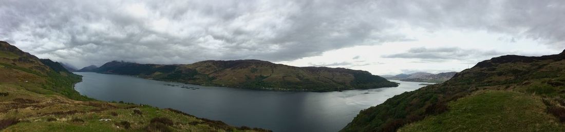 Panoramic view of sea and mountains against sky