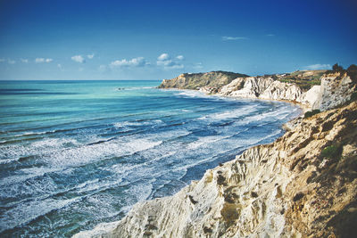 Scenic view of beach against blue sky