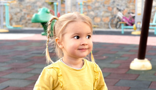 Portrait of cute caucasian girl smiling and looking ahead