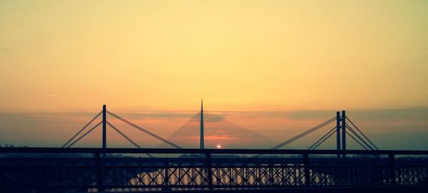 Scenic view of bridge against sky at sunset