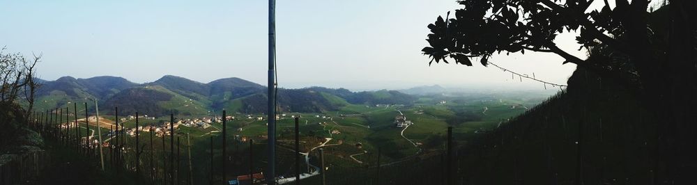 Scenic view of village down valley against clear sky