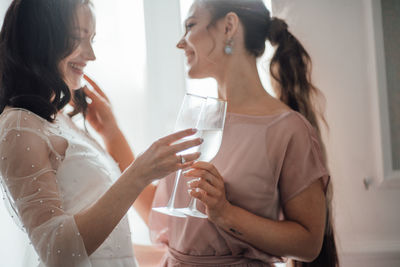 Young woman drinking water from glass