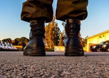 Low section of man wearing shoes on street