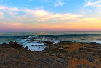 Scenic view of sea against cloudy sky