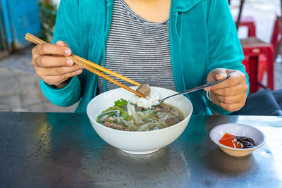 Midsection of woman eating food