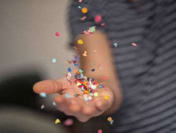 Close-up of hand holding multi colored lights