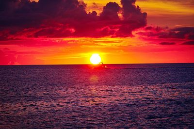 Scenic view of sea against romantic sky at sunset