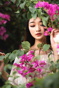 Portrait of woman with pink flowers