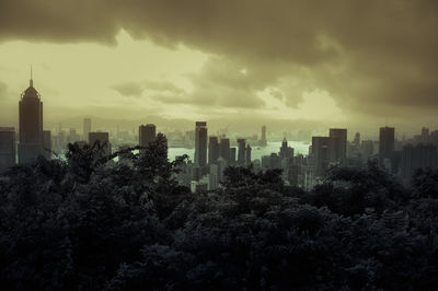 View of modern buildings in city against cloudy sky