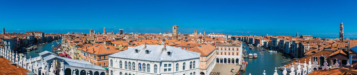 High angle view of buildings against blue sky