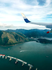 Airplane flying over sea against sky