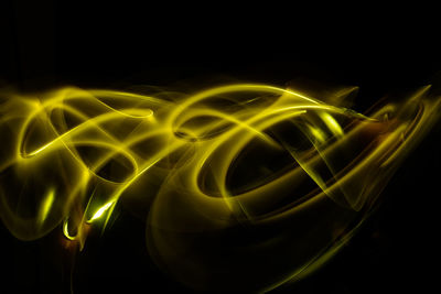 Close-up of light painting against black background