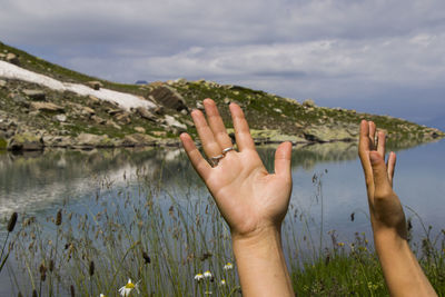 Woman hands close-up on the lake background, hands and nature in georgia.