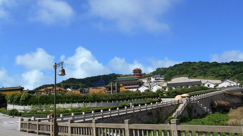 Panoramic view of buildings and bridge against sky