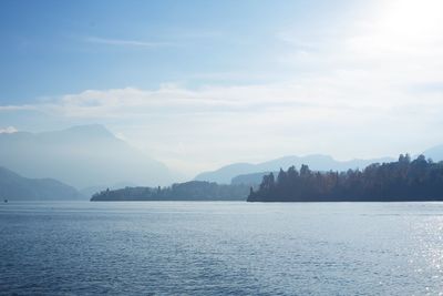 Scenic view of lake by mountains against sky