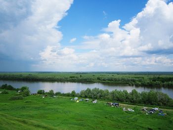 Scenic view of lake against cloudy sky