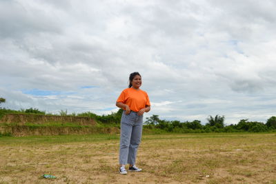 Full length of women standing on field against sky